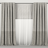 Gray curtains with tulle and roman blinds.