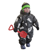 Child in overalls with a toy shovel