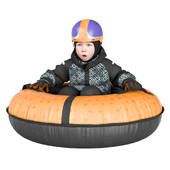 A child in a helmet rides a snow tubing